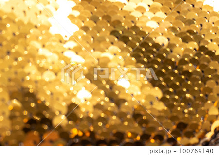 Abstract background of golden sequins with selective focus as texture Abstract background of golden sequins with selective focus as texture 100769140