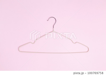 Creative flat lay hanger pastel pink background. Sale discount store promo shopping concept. Top view Creative flat lay hanger pastel pink background. Sale discount store promo shopping concept. Top view 100769758