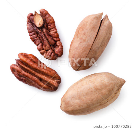 Pecan nut peeled and in shell on a white background. Top view Pecan nut peeled and in shell on a white background. Top view 100770285