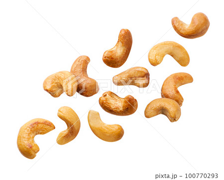 Roasted cashews flying on a white background. Isolated 100770293