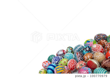 A collection of colorful Easter eggs arranged close together in the lower corner of the frame. 100770979