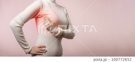 Woman hands checking lumps on her breast for signs of breast cancer on pink background. Healthcare world health day concept. Woman hands checking lumps on her breast for signs of breast cancer on pink background. Healthcare world health day concept. 100772652