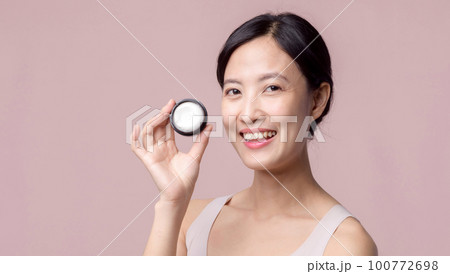 Young asian woman with facial skincare face cream, cosmetic moisturiser on healthy natural skin make up face. Portrait glowing smile girl person model with care beauty product, spa, cosmetology. Young asian woman with facial skincare face cream, cosmetic moisturiser on healthy natural skin make up face. Portrait glowing smile girl person model with care beauty product, spa, cosmetology. 100772698