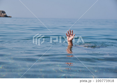 Hand of person drowning in water. Hand of person drowning in water. 100773918