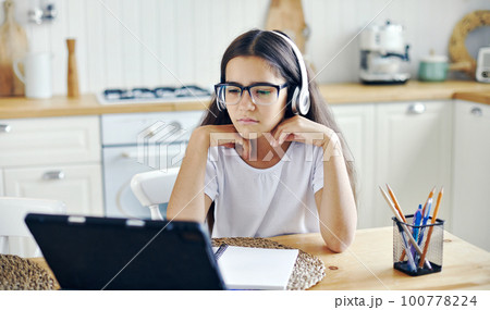 Girl e-learning, use tech, experiences vision problems Girl e-learning, use tech, experiences vision problems 100778224