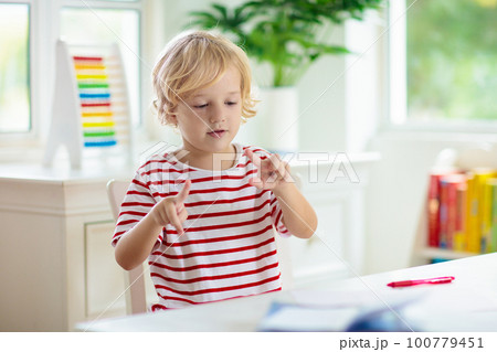 Child doing school homework. Online learning. Child doing school homework. Online learning. 100779451