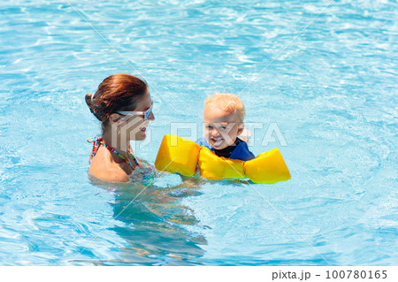 Mother and baby in swimming pool Mother and baby in swimming pool 100780165