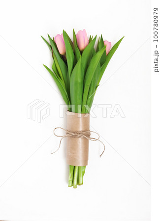 Bouquet of light pink tulips packed in kraft paper in retro style isolated on white background 100780979