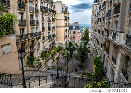 Narrow Alley With Ancient Buildings And Stairs At Montmartre Hill In Paris, France Narrow Alley With Ancient Buildings And Stairs At Montmartre Hill In Paris, France 100781145