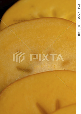 Half-cut ripe and sweet persimmon, close up Half-cut ripe and sweet persimmon, close up 100782198