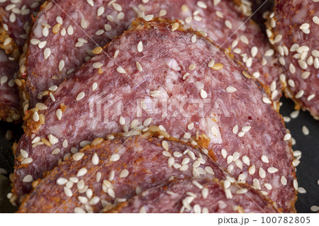 Sliced beef sausage with spices and lots of sesame seeds Sliced beef sausage with spices and lots of sesame seeds 100782805