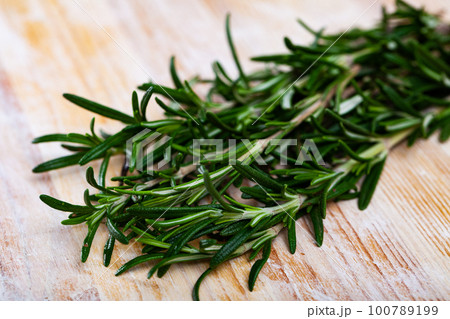 Closeup of rosemary on wooden table 100789199