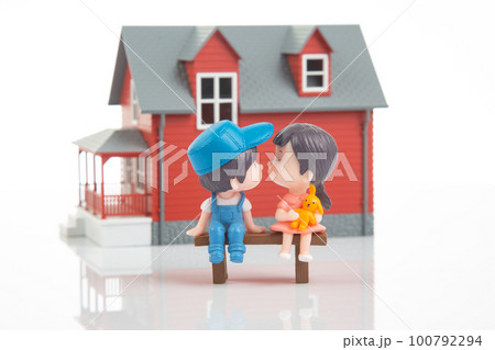 miniature people. romantic couple of young people near the house model miniature people. romantic couple of young people near the house model 100792294