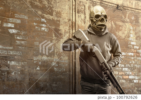 Man wearing a mask holding a gun Man wearing a mask holding a gun 100792626