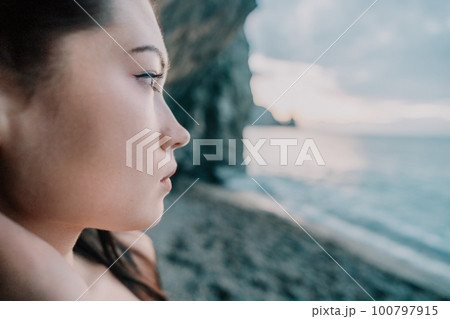 Portrait of cheerful female climber resting on a volcanic basalt Portrait of cheerful female climber resting on a volcanic basalt 100797915