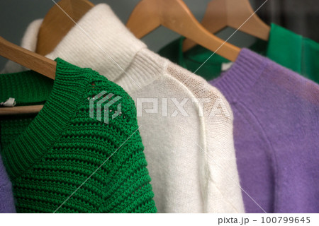 Closeup of colorful woolen pullover on hangers in a fashion store showroom 100799645