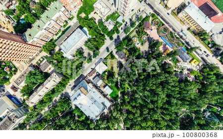 Aerial city view with crossroads and roads, houses, buildings, parks and parking lots. Sunny summer panoramic image Aerial city view with crossroads and roads, houses, buildings, parks and parking lots. Sunny summer panoramic image 100800368