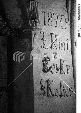 Grayscale shot of lettering made of human bones in the Sedlec Ossuary in Kutna Hora, Czech Republic 100800603