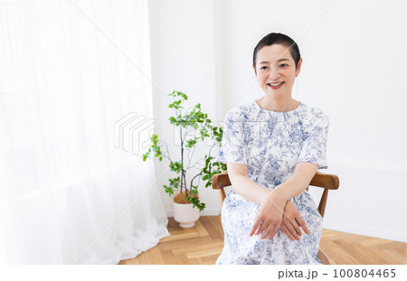 笑顔で座る女性 100804465