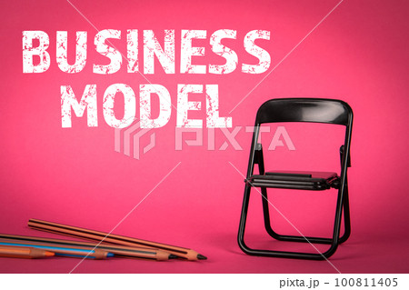 BUSINESS MODEL concept. Miniature chair and pencils on a pink background 100811405