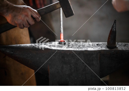 Smithy on the anvil 100813852