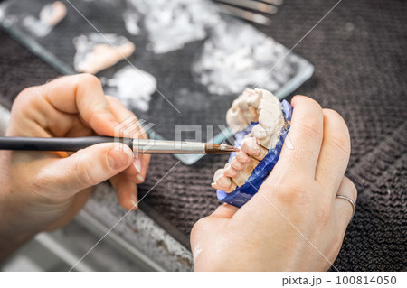 Dental technician working Dental technician working 100814050