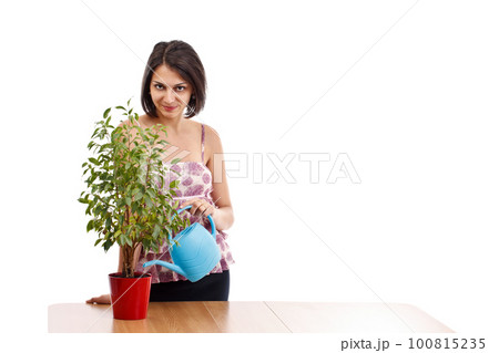 Young woman watering Young woman watering 100815235