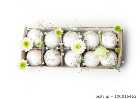 Egg box with eggs and flowers isolated on white background 100816462