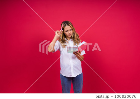 Child making notes. Kids dreams.Isolated on red background. Education, Kid back to school. 100820076