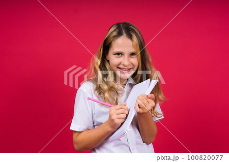 Child making notes. Kids dreams.Isolated on red background. Education, Kid back to school. 100820077