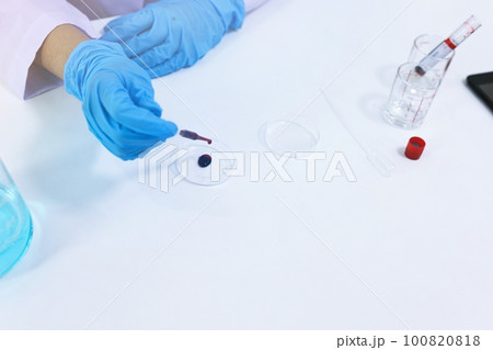Scientist holding Coronavirus covid-19 infected blood sample tube DNA testing of the blood in the laboratory with blood sample collection tubes and syringe Coronavirus Covid-19 vaccine research. Scientist holding Coronavirus covid-19 infected blood sample tube DNA testing of the blood in the laboratory with blood sample collection tubes and syringe Coronavirus Covid-19 vaccine research. 100820818