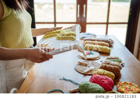 Punch needle. Asian Woman making handmade Hobby knitting in studio workshop. designer workplace Handmade craft project DIY embroidery concept. Punch needle. Asian Woman making handmade Hobby knitting in studio workshop. designer workplace Handmade craft project DIY embroidery concept. 100821183