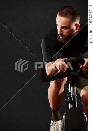 Portrait of a cyclist with a beard on a dark background Portrait of a cyclist with a beard on a dark background 100821513