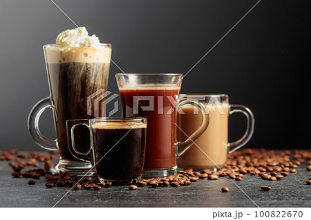 Various coffee and chocolate drinks on a black table. 100822670