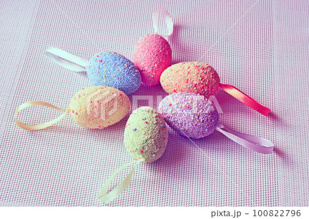 Multi colored Easter eggs on a woven fabric in pink 100822796