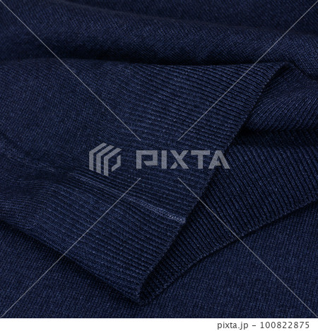Knitted elastic band on navy blue wool jumper close up Knitted elastic band on navy blue wool jumper close up 100822875