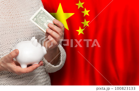 Chinese woman with money bank on the background of China flag. Dotations, pension fund, poverty Chinese woman with money bank on the background of China flag. Dotations, pension fund, poverty 100823133