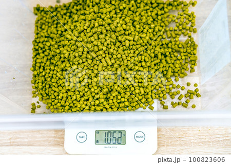 weighing granules from hops in the brewery during the production of beer weighing granules from hops in the brewery during the production of beer 100823606