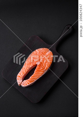 Fresh raw red fish steak with spices and herbs 100824347