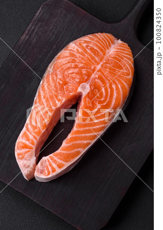 Fresh raw red fish steak with spices and herbs 100824350