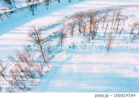 Aerial View Flight Above Frozen Creek. Amazing Aerial View On Freezing River. Scenic View Of Nature. Snowy Winter Sunny Day Aerial View Flight Above Frozen Creek. Amazing Aerial View On Freezing River. Scenic View Of Nature. Snowy Winter Sunny Day 100824594