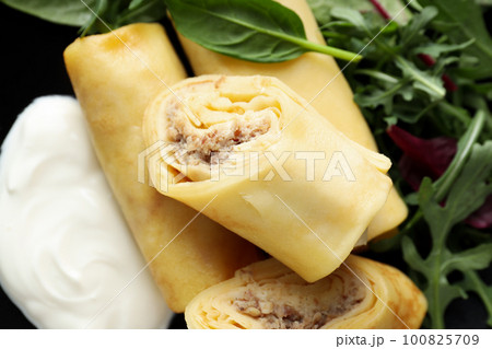 Concept of tasty food, thin pancakes with filling 100825709