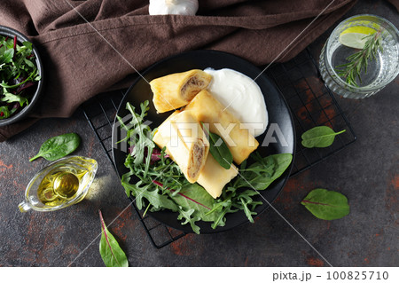 Concept of tasty food, thin pancakes with filling, top view Concept of tasty food, thin pancakes with filling, top view 100825710