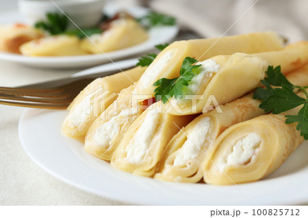 Concept of tasty food, thin pancakes with filling Concept of tasty food, thin pancakes with filling 100825712