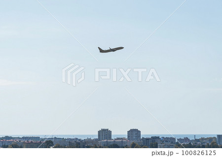 the plane is flying against a background of blue sky and sun the plane is flying against a background of blue sky and sun 100826125
