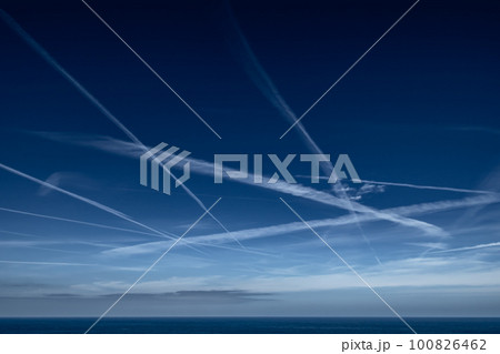 Blue Sky With Grid Of White Condensation Trails, Contrails, From Airplane At The Atlantic Coast In France Blue Sky With Grid Of White Condensation Trails, Contrails, From Airplane At The Atlantic Coast In France 100826462