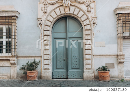 Old street in historical town, beautiful old door with Plants decorations in Rome, Italy 100827180