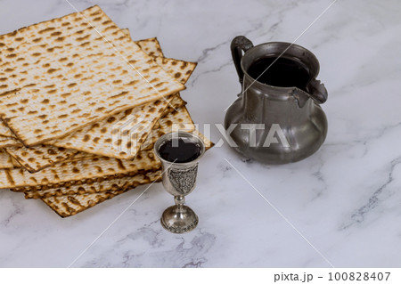 Passover consists of kosher unleavened matzah bread and kosher kiddush wine for Pesach 100828407