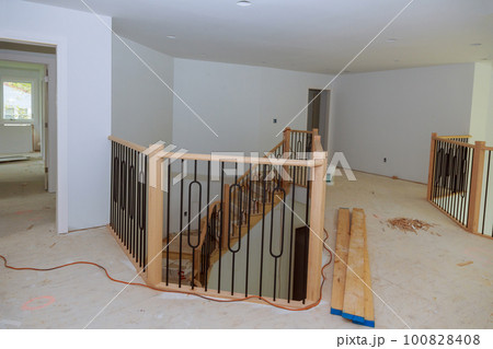 Large amount of progress is being made on assembly and installation of wooden railings in new house. 100828408