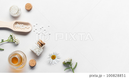 Homeopathic medicines and medicinal plants on a light background, copy space, flatlay Homeopathic medicines and medicinal plants on a light background, copy space, flatlay 100828851